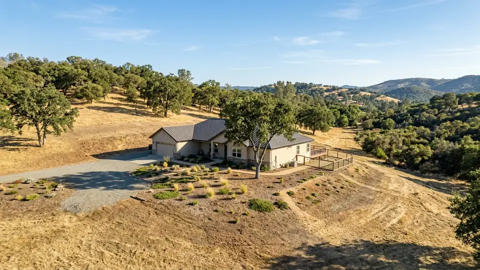 California foothill home with defensible space clearing and clean rain gutters